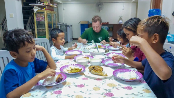 Eugene with children in a shelter